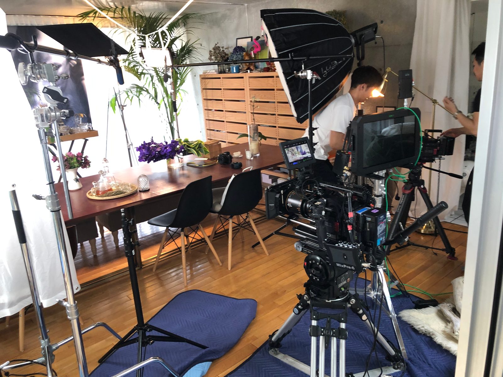 A busy set with lights, camera and crew